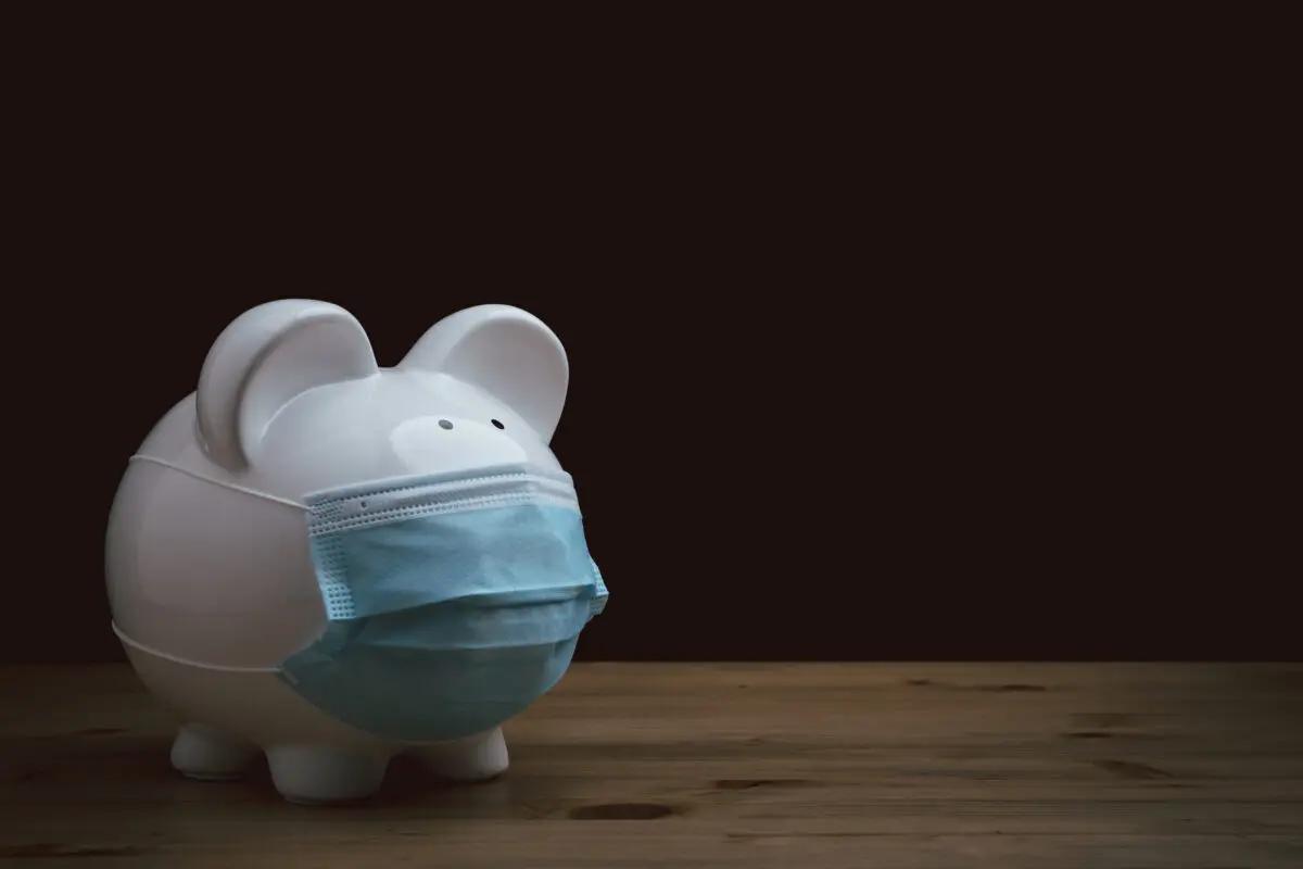 Ceramic piggy bank wearing a fabric face mask